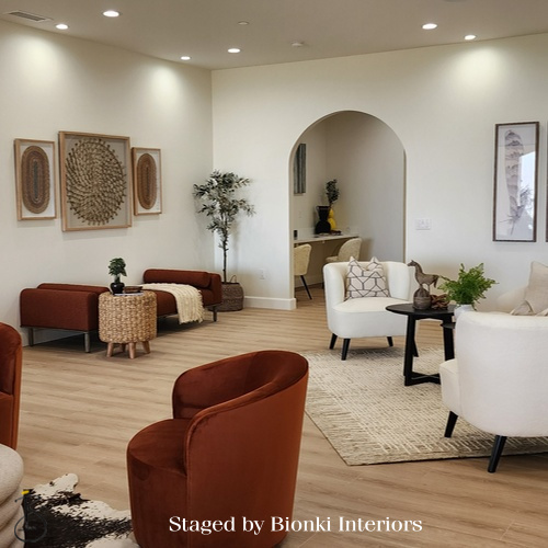 Luxury vacant home staging for a welcoming living space featuring arched architectural details and warm accent seating. Staged by Bionki Interiors. Luxury vacant home staging for a welcoming living space featuring arched architectural details and warm accent seating. Staged by Bionki Interiors.