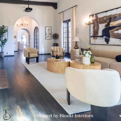 Luxury open-concept living room staging featuring arched architectural details and statement artwork. Staged by Bionki Interiors. Luxury open-concept living room staging featuring arched architectural details and statement artwork. Staged by Bionki Interiors.