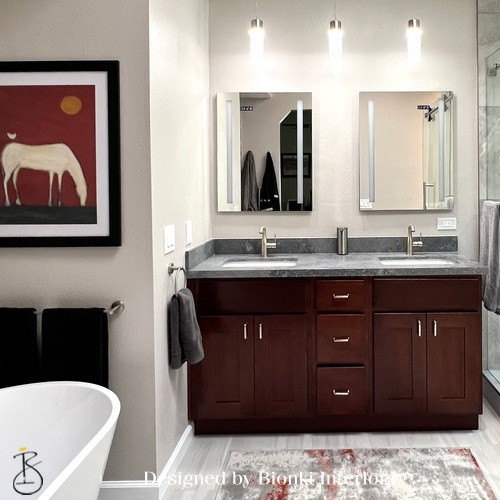 Custom bathroom design featuring a double vanity, modern fixtures, and layered lighting. Designed by Bionki Interiors.