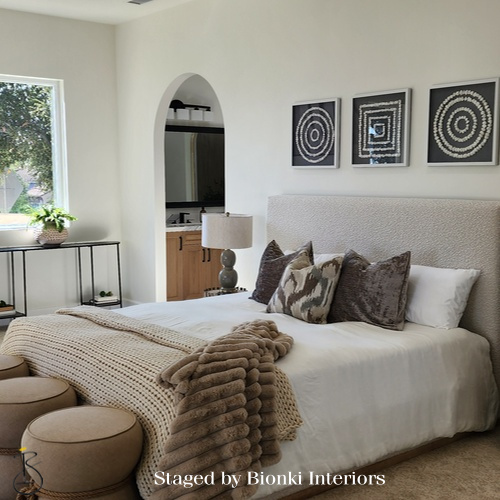 Luxury primary bedroom staging with soft neutral bedding, layered textiles, and balanced furniture placement designed to create an inviting retreat. Staged by Bionki Interiors. Luxury primary bedroom staging with soft neutral bedding, layered textiles, and balanced furniture placement designed to create an inviting retreat. Staged by Bionki Interiors.