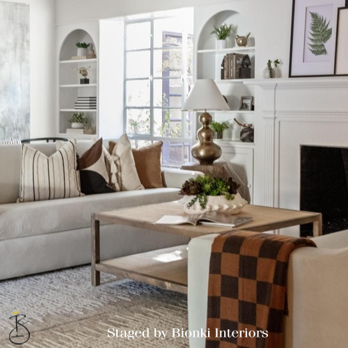 Luxury living room staging featuring built-in shelving and a fireplace focal point. Staged by Bionki Interiors. Luxury living room staging featuring built-in shelving and a fireplace focal point. Staged by Bionki Interiors.