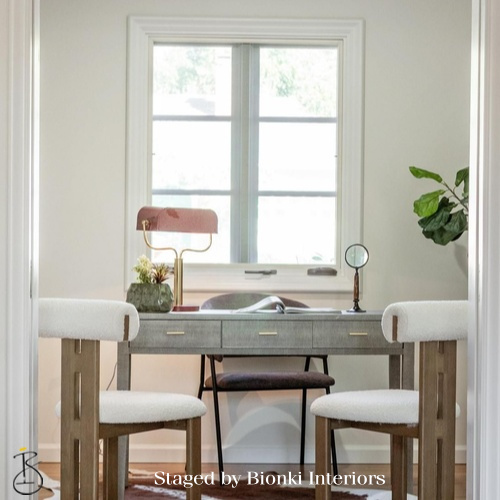 Luxury home office staging featuring a compact desk, sculptural lamp, and natural light. Staged by Bionki Interiors. Luxury home office staging featuring a compact desk, sculptural lamp, and natural light. Staged by Bionki Interiors.