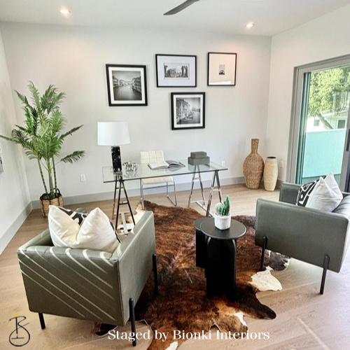 Luxury open-concept staging featuring a living area with an adjacent workspace and cohesive styling. Staged by Bionki Interiors. Luxury open-concept staging featuring a living area with an adjacent workspace and cohesive styling. Staged by Bionki Interiors.
