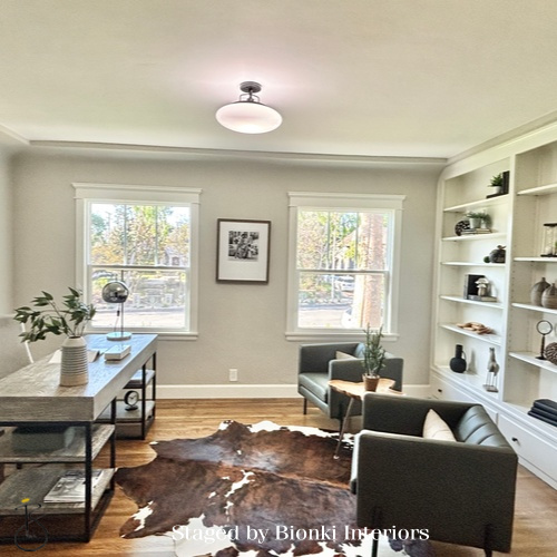 Luxury open-concept living and dining staging featuring built-in shelving and flexible layout design. Staged by Bionki Interiors. Luxury open-concept living and dining staging featuring built-in shelving and flexible layout design. Staged by Bionki Interiors.