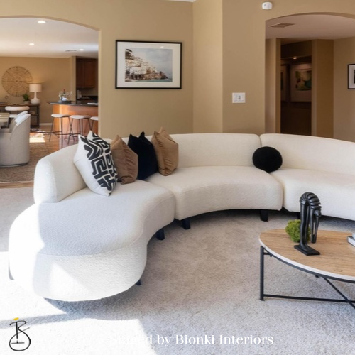 Luxury vacant home staging for a modern living room featuring curved seating and soft textures. Staged by Bionki Interiors. Luxury vacant home staging for a modern living room featuring curved seating and soft textures. Staged by Bionki Interiors.