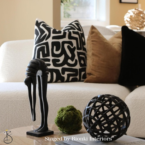 Luxury living room detail styling featuring sculptural accessories and patterned pillows. Styled by Bionki Interiors. Luxury living room detail styling featuring sculptural accessories and patterned pillows. Styled by Bionki Interiors.