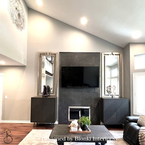 Custom living room design featuring a fireplace focal wall and integrated media elements. Designed by Bionki Interiors.