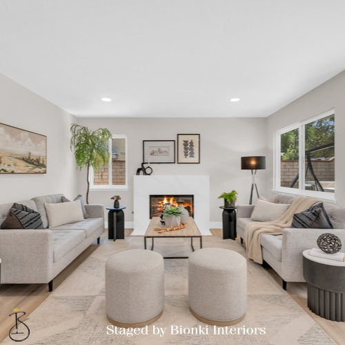 Luxury vacant home staging for a cozy living room featuring layered seating and warm neutral tones. Staged by Bionki Interiors. Luxury vacant home staging for a cozy living room featuring layered seating and warm neutral tones. Staged by Bionki Interiors.