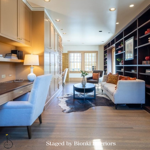 Luxury vacant home staging for a modern living room featuring built-in shelving and warm wood flooring. Staged by Bionki Interiors. Luxury vacant home staging for a modern living room featuring built-in shelving and warm wood flooring. Staged by Bionki Interiors.