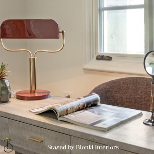 Luxury home office detail styling featuring sculptural desk lighting and layered accessories. Styled by Bionki Interiors. Luxury home office detail styling featuring sculptural desk lighting and layered accessories. Styled by Bionki Interiors.