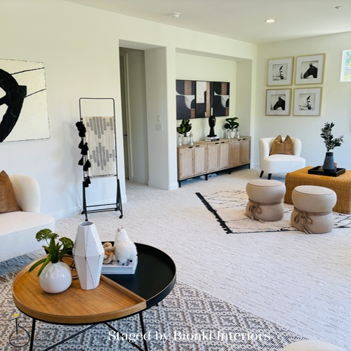 Luxury vacant home staging for a bright living room with layered furnishings and sculptural accents designed to enhance scale and flow. Staged by Bionki Interiors. Luxury vacant home staging for a bright living room with layered furnishings and sculptural accents designed to enhance scale and flow. Staged by Bionki Interiors.