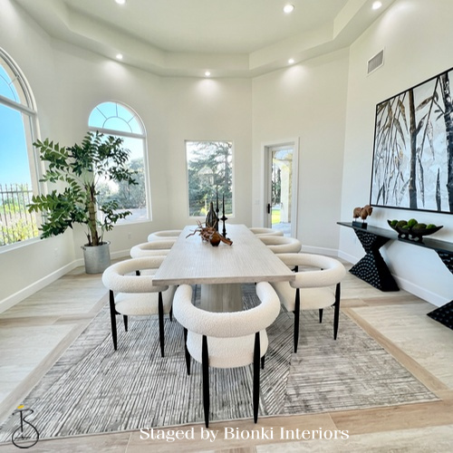 Luxury dining room staging in a light-filled space featuring a long table and sculptural seating designed to showcase entertaining potential. Staged by Bionki Interiors. Luxury dining room staging in a light-filled space featuring a long table and sculptural seating designed to showcase entertaining potential. Staged by Bionki Interiors.