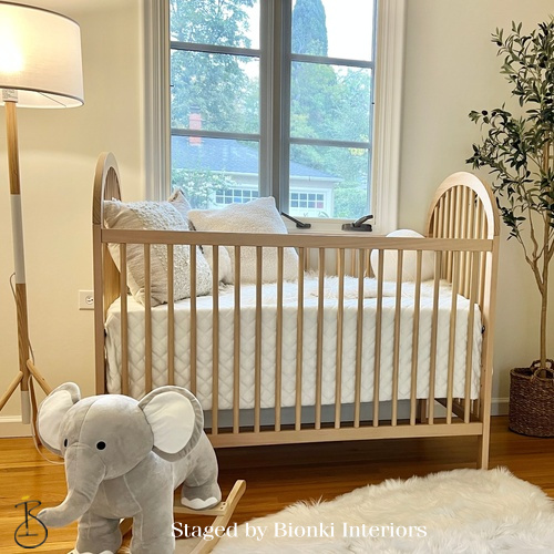 Luxury nursery staging featuring a natural wood crib and soft neutral textiles. Staged by Bionki Interiors. Luxury nursery staging featuring a natural wood crib and soft neutral textiles. Staged by Bionki Interiors.